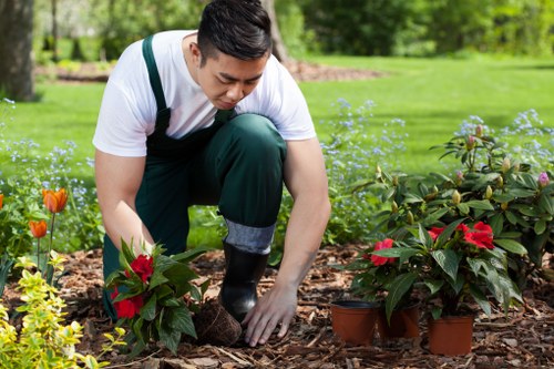 Workers sorting garden waste into recycling streams at a site